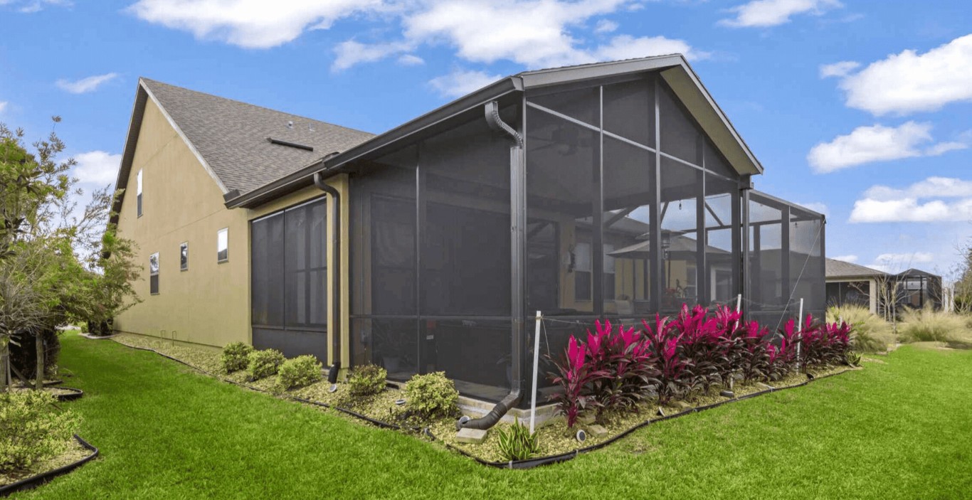 Screen room with dark mesh attached to residential home in Delray Beach, FL